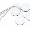 Set of four white round TENS electrode pads with attached lead wires, used for electrical nerve stimulation therapy.